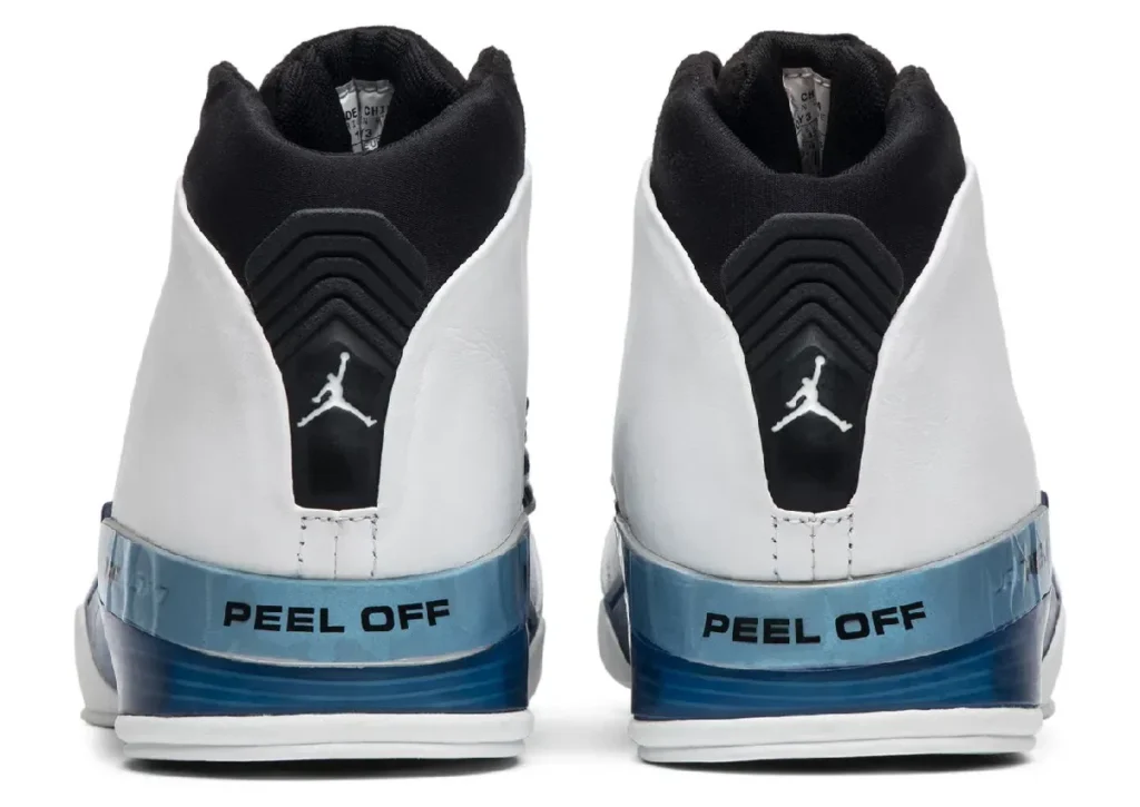 Rear view of Air Jordan 17 “College Blue” showing white leather upper, black padded collar, ribbed heel spine with Jumpman logo, and blue gradient midsole with “PEEL OFF” text detailing