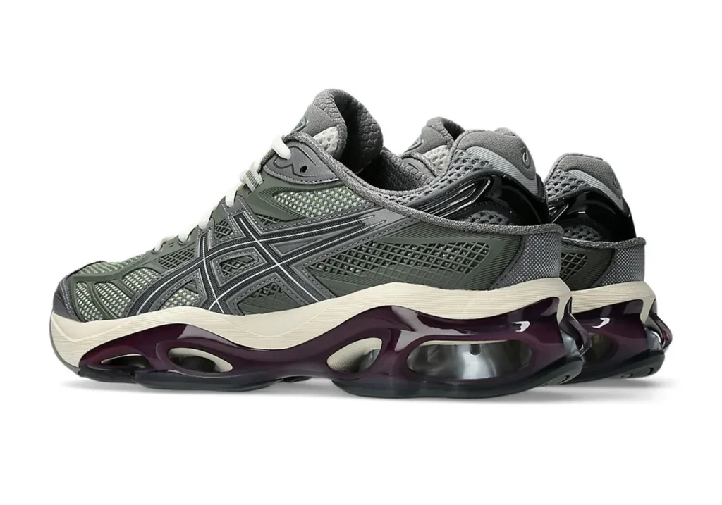 Pair of ASICS GEL-Kinetic 2.0 ‘Lichen Green’ shoe shown from a front three-quarter angle. The premium Sportstyle model features a detailed lichen green mesh and synthetic upper with bold ASICS Tiger stripes, off-white midsole, and a striking translucent dark burgundy GEL cushioning unit with visible silver scutoid GEL pods