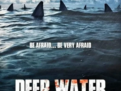 Poster for Deep Water (2026) showing a damaged airplane descending over a stormy ocean while multiple shark fins circle in the water below, with the tagline “Be Afraid… Be Very Afraid.”