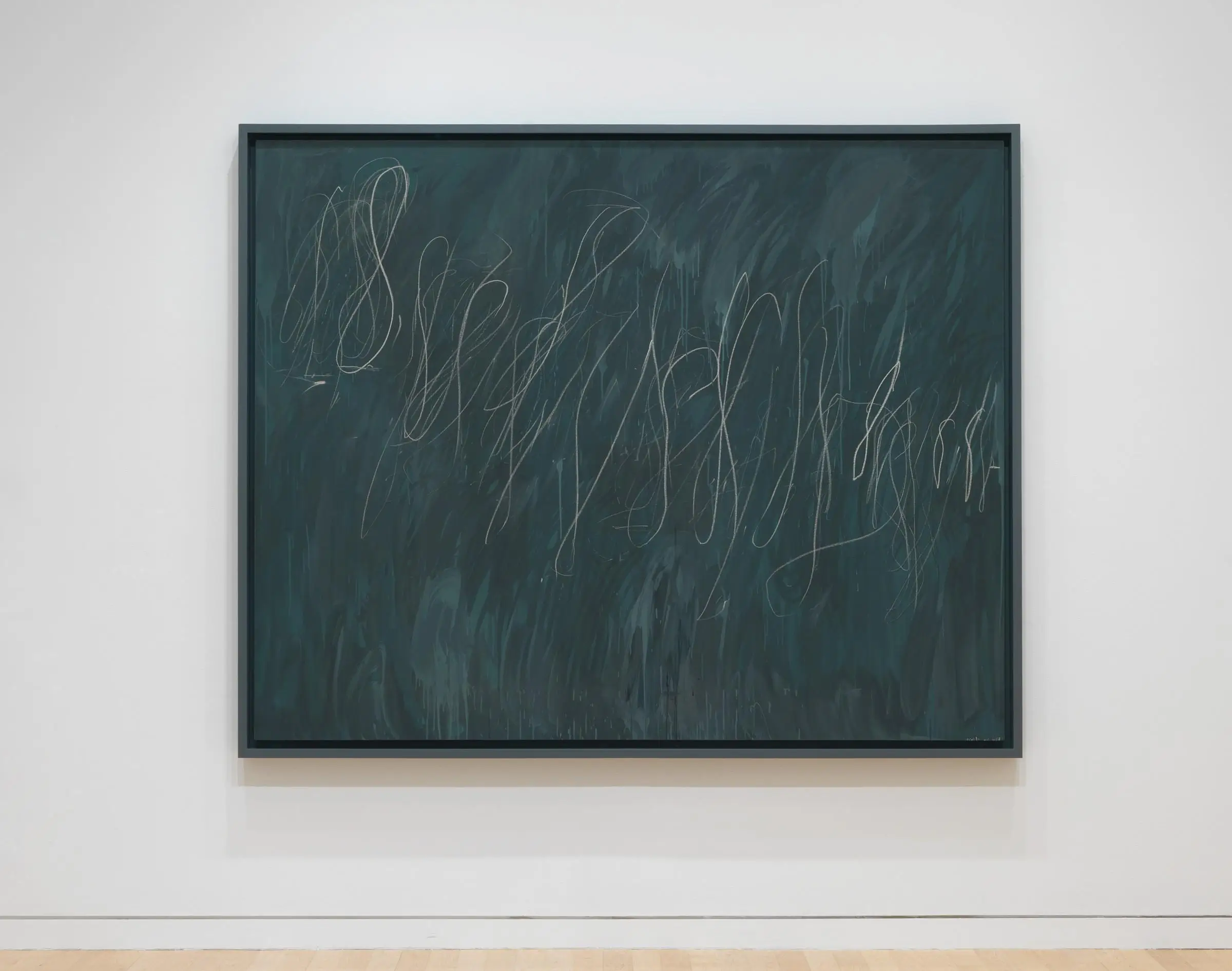 A framed abstract painting mounted on a white gallery wall, featuring a deep teal background layered with textured brushstrokes and thin, looping white lines that resemble gestural scribbles or calligraphic marks