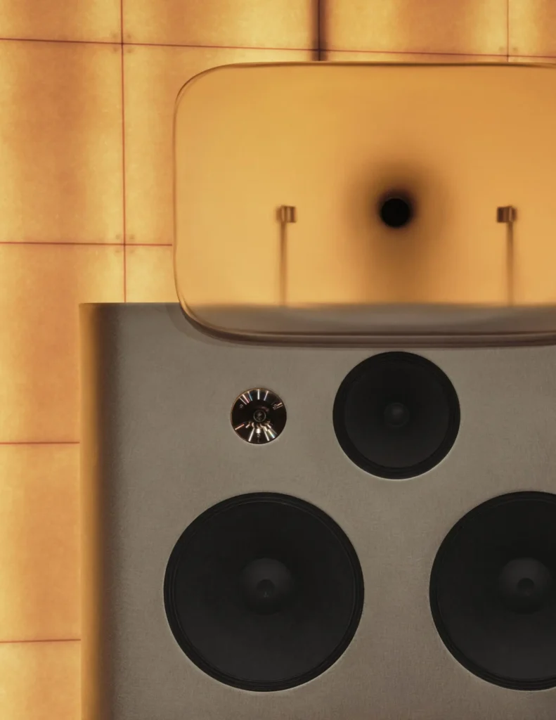 Custom speaker system in Spotify’s London Listening Lounge featuring multiple drivers and a sculptural acoustic design against warm backlit panels