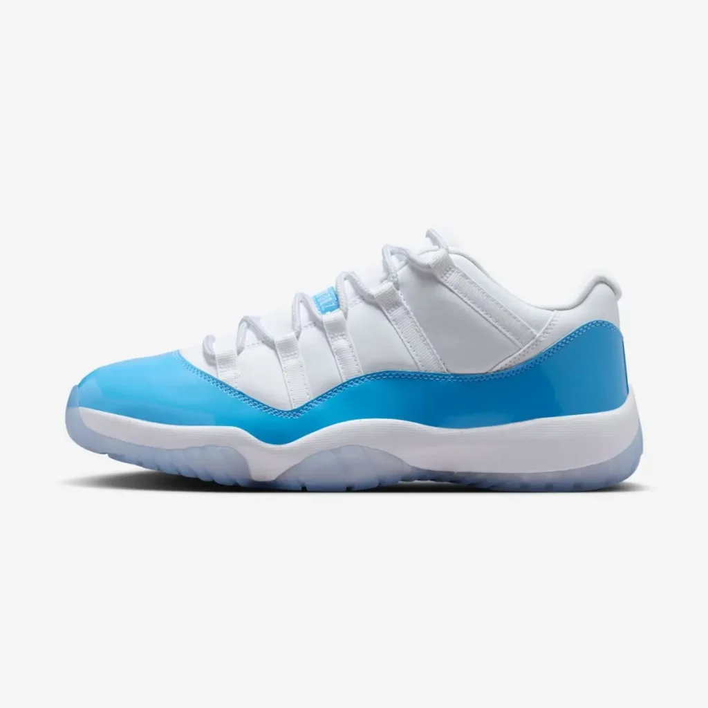 Air Jordan 11 Low UNC 2026 in white leather with Carolina blue patent leather mudguard, shown in a clean lateral side profile with icy translucent outsole