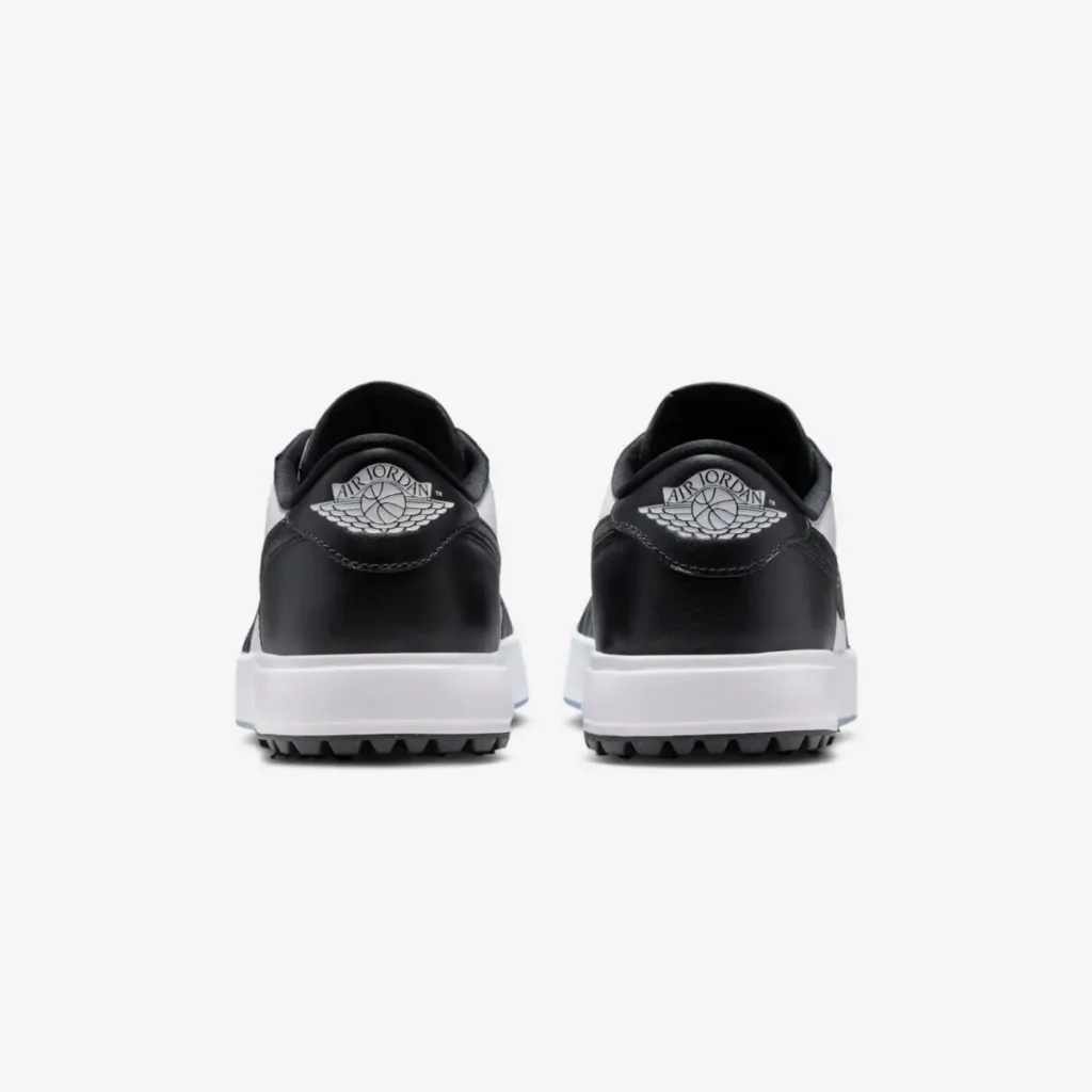 Rear view of Air Jordan 1 Low Golf Spiked Concord showing black leather heel panels with white Wings logo, white midsole, and rugged spiked outsole for traction