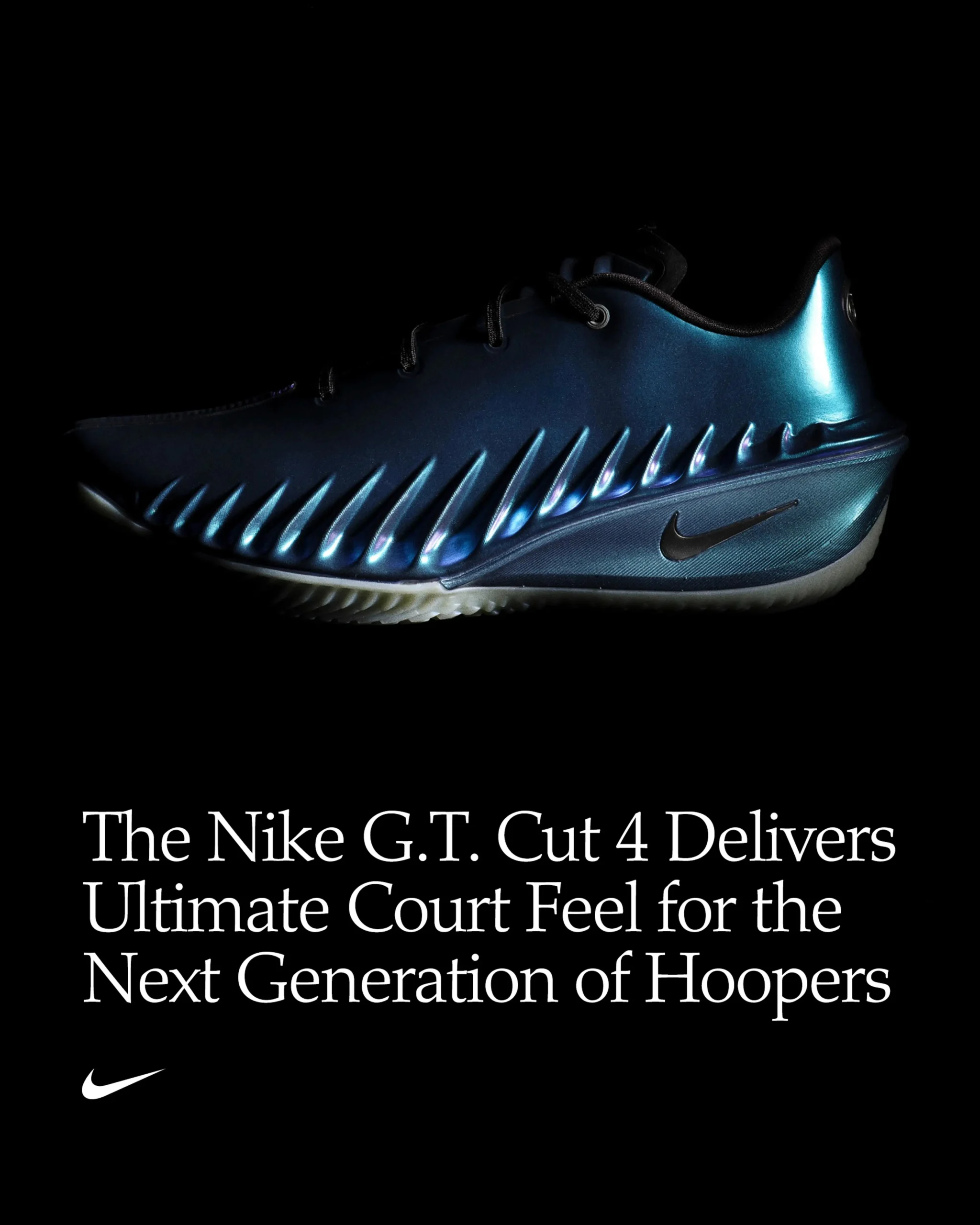 Moody studio image of a Nike G.T. Cut 4 basketball shoe in an iridescent blue finish, side-lit against a black background to highlight its sculpted, ribbed upper and sleek silhouette, with headline text reading “The Nike G.T. Cut 4 Delivers Ultimate Court Feel for the Next Generation of Hoopers” and a small Swoosh logo below