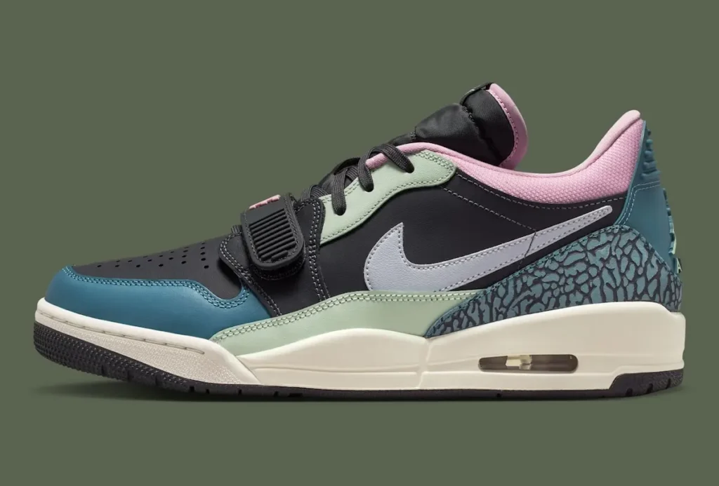 A lateral side view of a Nike Air Jordan low-top shoe, showcasing its hybrid design and layered color palette. The shoe features a black leather base with mint green overlays and a teal mudguard, contrasted by a soft pink padded collar. A light grey Nike Swoosh extends across the side panel, while the heel is wrapped in textured elephant-print detailing in teal and black. The off-white midsole includes a visible Air unit at the heel, emphasizing its performance heritage, and the forefoot strap paired with black laces reinforces its retro basketball-inspired aesthetic