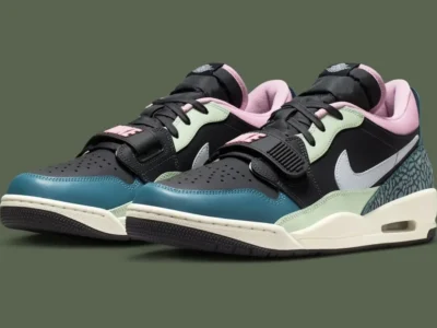 A pair of Nike Air Jordan low-top sneakers displayed side by side, featuring a bold mix of textures and colors. The shoes combine a black leather base with pastel accents—mint green overlays, a pink padded collar, and teal elephant-print detailing at the heel. A crisp white Nike Swoosh cuts across the side panels, while the forefoot strap with raised “NIKE” branding adds a retro basketball edge. The off-white midsole houses a visible Air unit, grounding the design in classic performance heritage, while the dark outsole and perforated toe box complete the layered, street-ready aesthetic