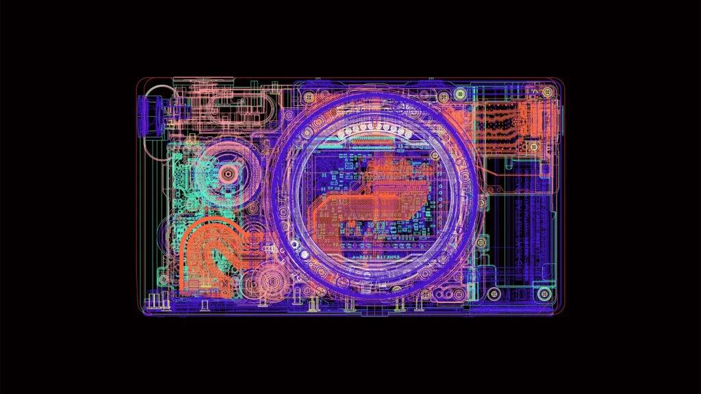 A detailed, colorful x-ray-style diagram of a compact camera reveals its internal components, with layered circuitry, lens structure, and mechanical elements rendered in vibrant overlapping lines against a black background