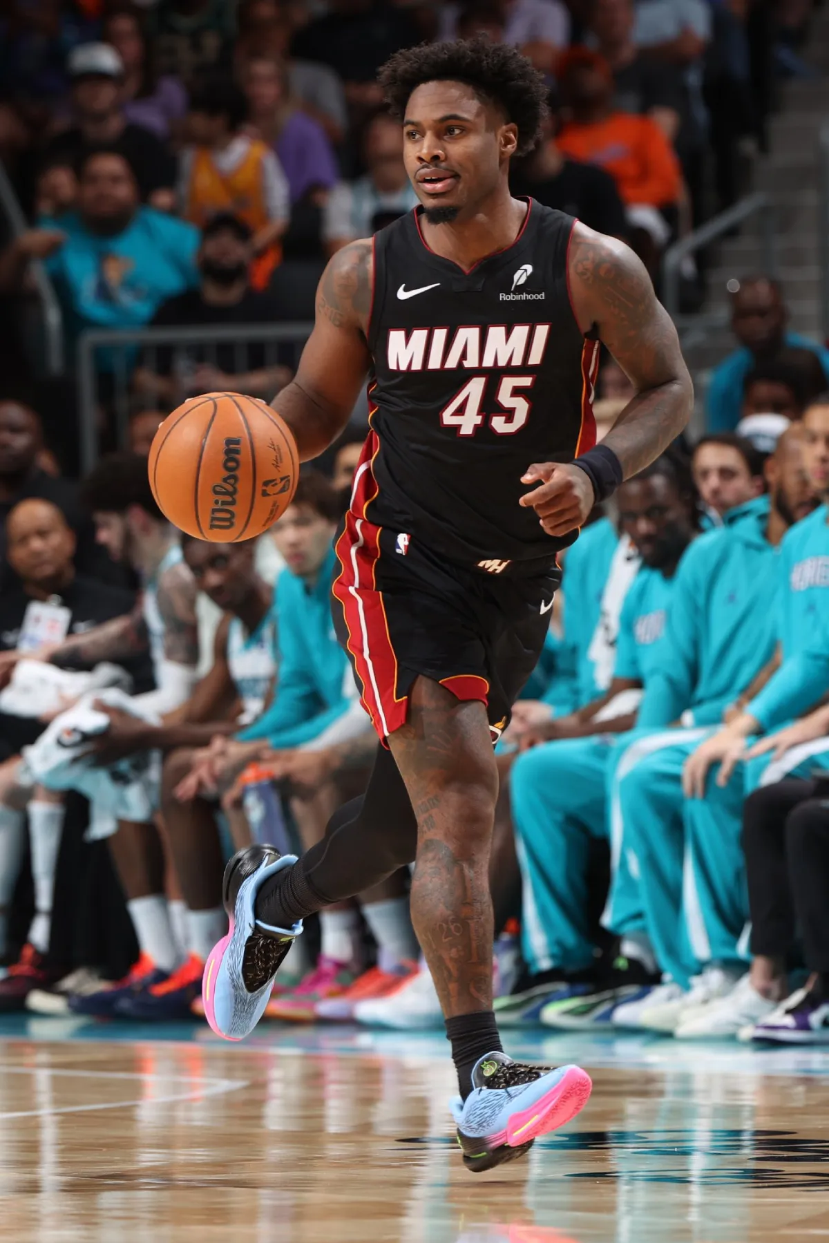 Davion Mitchell dribbling during an NBA game for the Miami Heat wearing UA Curry Fox 3