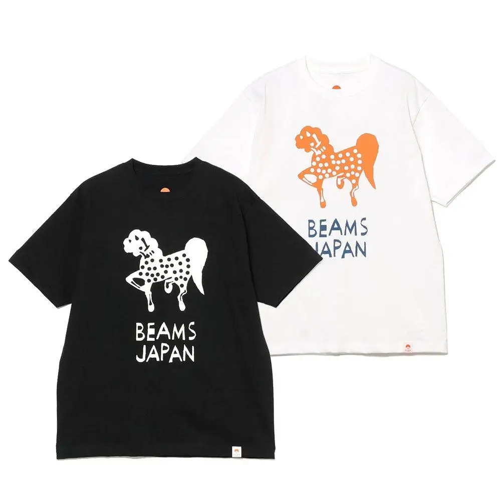 Two BEAMS JAPAN T-shirts in black and white featuring a playful, cut-paper style animal graphic with polka dots and hand-drawn text, set against a clean neutral background