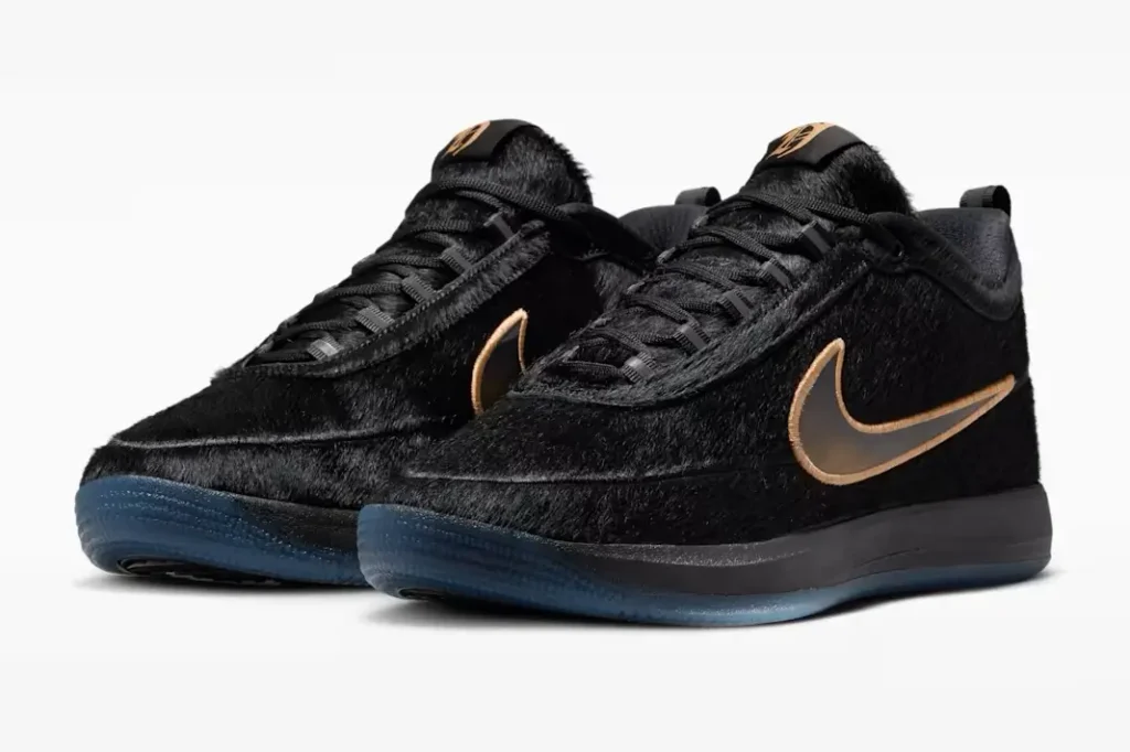 Pair of black furry Nike sneakers photographed in three-quarter perspective, emphasizing the luxurious pony hair construction, bronze accents, and icy blue outsole finish