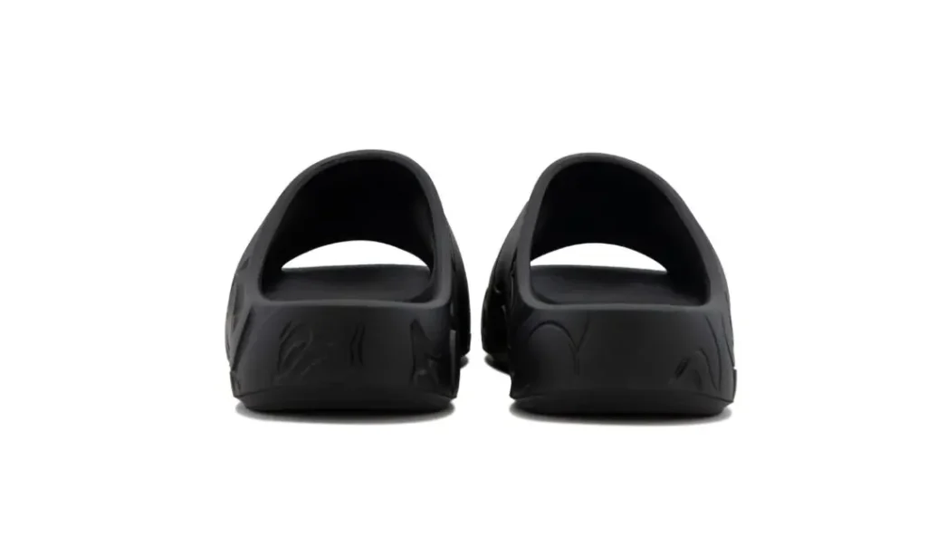 Rear view of black BAPE STA slides showcasing the open heel design, wide foot opening, and subtle camouflage detailing wrapping around the sides