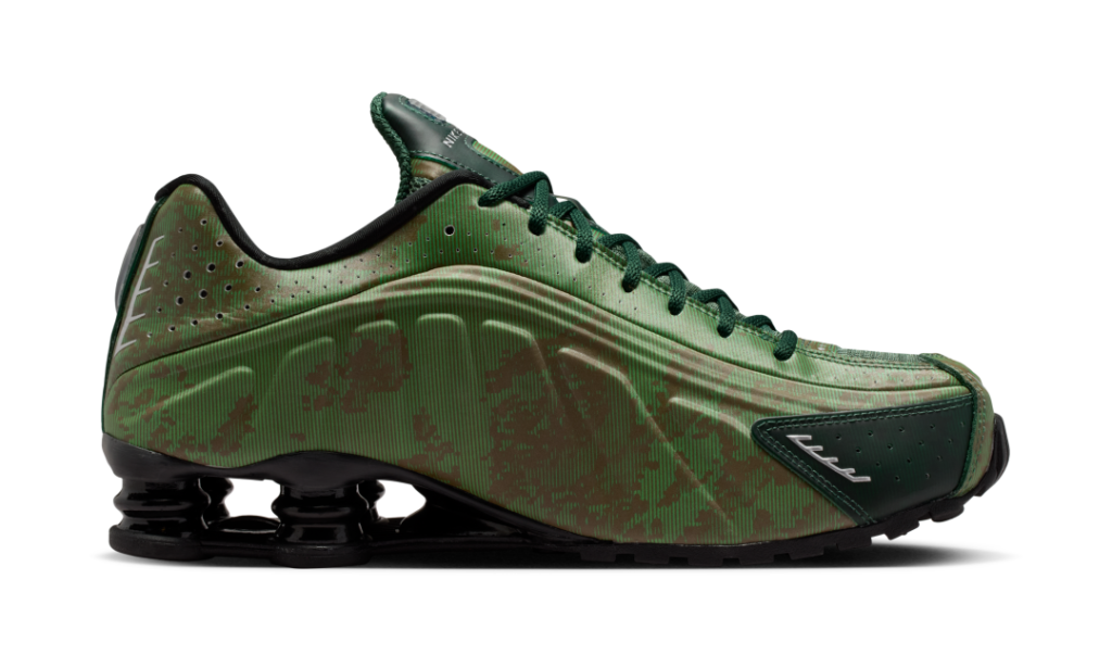 Medial side of the Nike Shox R4 in Noble Green featuring textured striping, tonal camouflage-like overlays, streamlined contours, and glossy black heel column