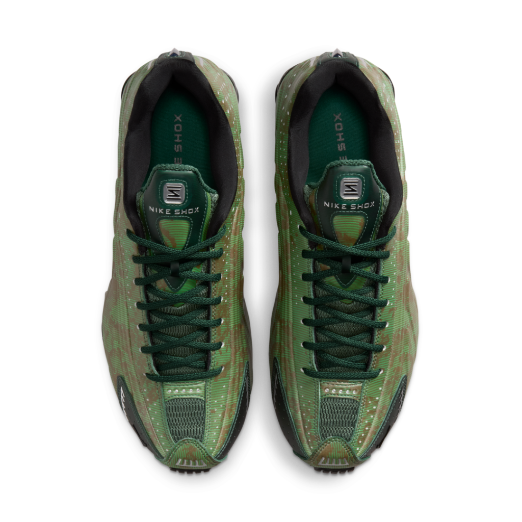 Top view of the Nike Shox R4 showing dark green rope laces, breathable mesh tongue, Nike Shox branding, and layered green textures across the upper