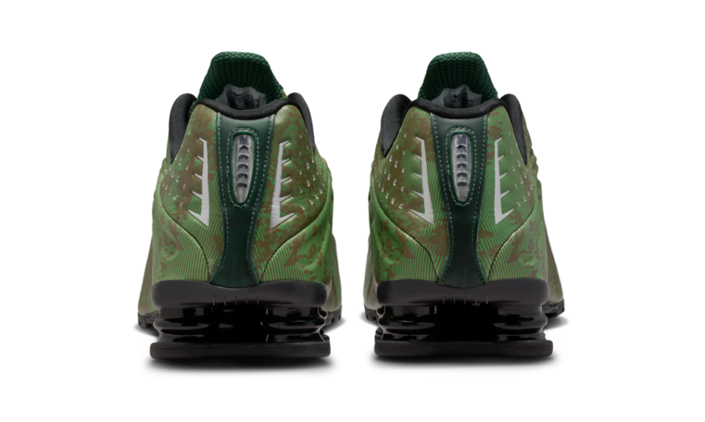 Rear angle of the Nike Shox R4 “Noble Green/Team Kelly Green” emphasizing reflective heel detailing, perforated panels, and stacked black Shox cushioning unit