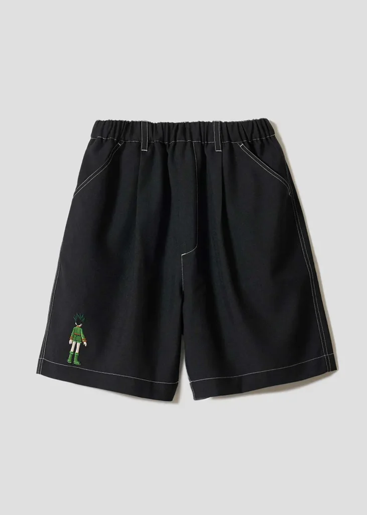 Black tailored shorts featuring contrast stitching and small embroidered anime character artwork near the hem