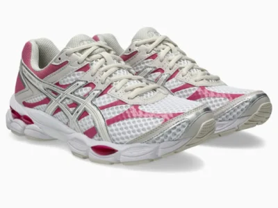 Three-quarter product view of a pair of ASICS GEL-CUMULUS 16 shoe showcasing the open mesh construction, cream lace system, and bright pink structural overlays
