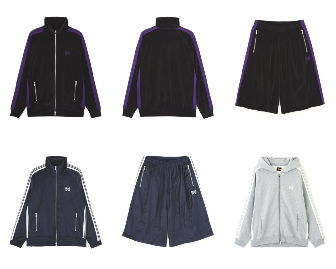 Minimal product grid featuring multiple NEEDLES trackwear pieces in classic sport-luxe colorways. The layout showcases black velour zip track jackets with signature purple side stripes, matching oversized shorts, a navy nylon set with white striping, and a light grey zip hoodie accented by NEEDLES’ embroidered Papillon butterfly logo. Silver zip hardware and relaxed silhouettes reinforce the label’s elevated Japanese athleisure aesthetic
