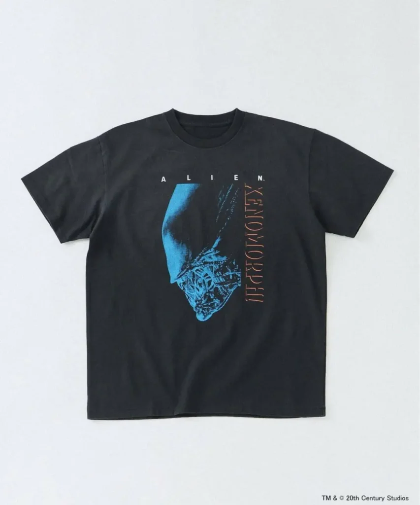 Front view of black Alien graphic T-shirt featuring a large blue-toned Xenomorph portrait with vertical typography and retro sci-fi poster style
