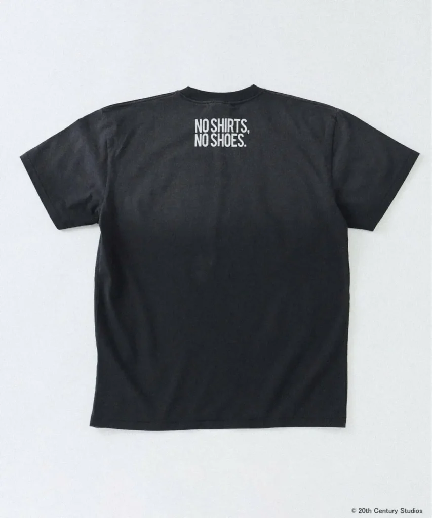 Back view of black minimalist movie T-shirt featuring bold white text reading “NO SHIRTS, NO SHOES.” centered below the collar