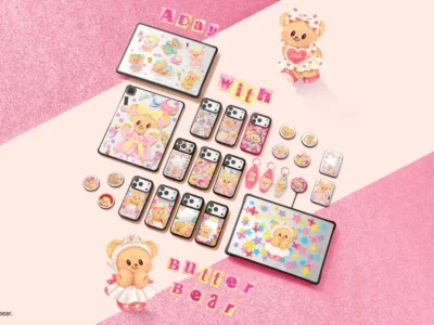 Flat lay promotional image of the CASETiFY x Butterbear collection featuring pastel pink backgrounds, dessert-themed phone cases, charms, stickers, and tech accessories arranged around tablets and smartphones with playful bakery-inspired graphics