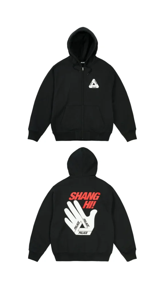 Front and back views of a black Palace zip-up hoodie featuring a small white Tri-Ferg logo on the chest and a large back graphic with bold red “SHANG HI!” lettering above a white hand illustration forming the iconic Palace triangle logo, created to celebrate the Shanghai flagship opening