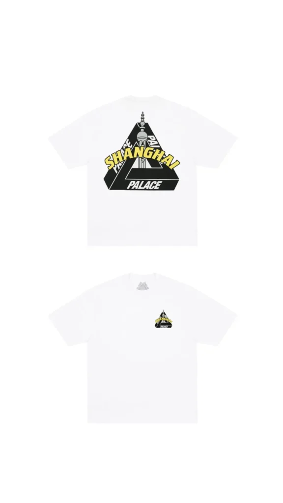 Front and back views of a white Palace graphic T-shirt featuring a small chest logo and a large back print of the iconic Tri-Ferg reimagined with a Shanghai skyline silhouette. Curved yellow “SHANGHAI” lettering overlays the black triangle graphic, creating a bold city-exclusive design for the Palace Shanghai flagship collection