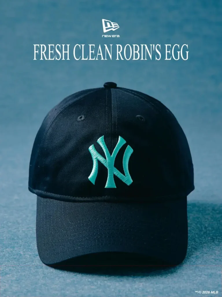 Front-facing black New Era 9FORTY Yankees cap featuring a vibrant Robin’s Egg Blue embroidered NY logo against smooth premium wool construction. Positioned beneath “Fresh Clean Robin’s Egg” typography on a cool textured blue backdrop, the minimalist design balances clean sportswear heritage with elevated tailoring-inspired refinement