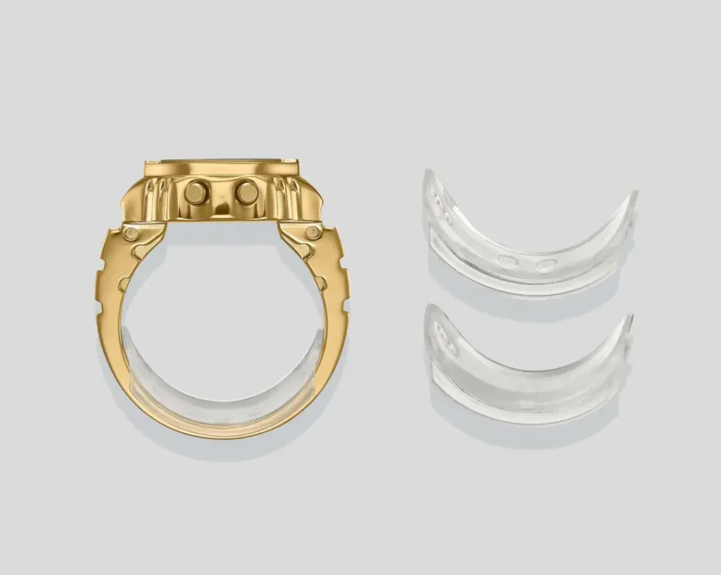Side profile view of the gold Casio Ring Watch with transparent sizing spacers displayed beside the miniature digital ring timepiece for adjustable fit custom