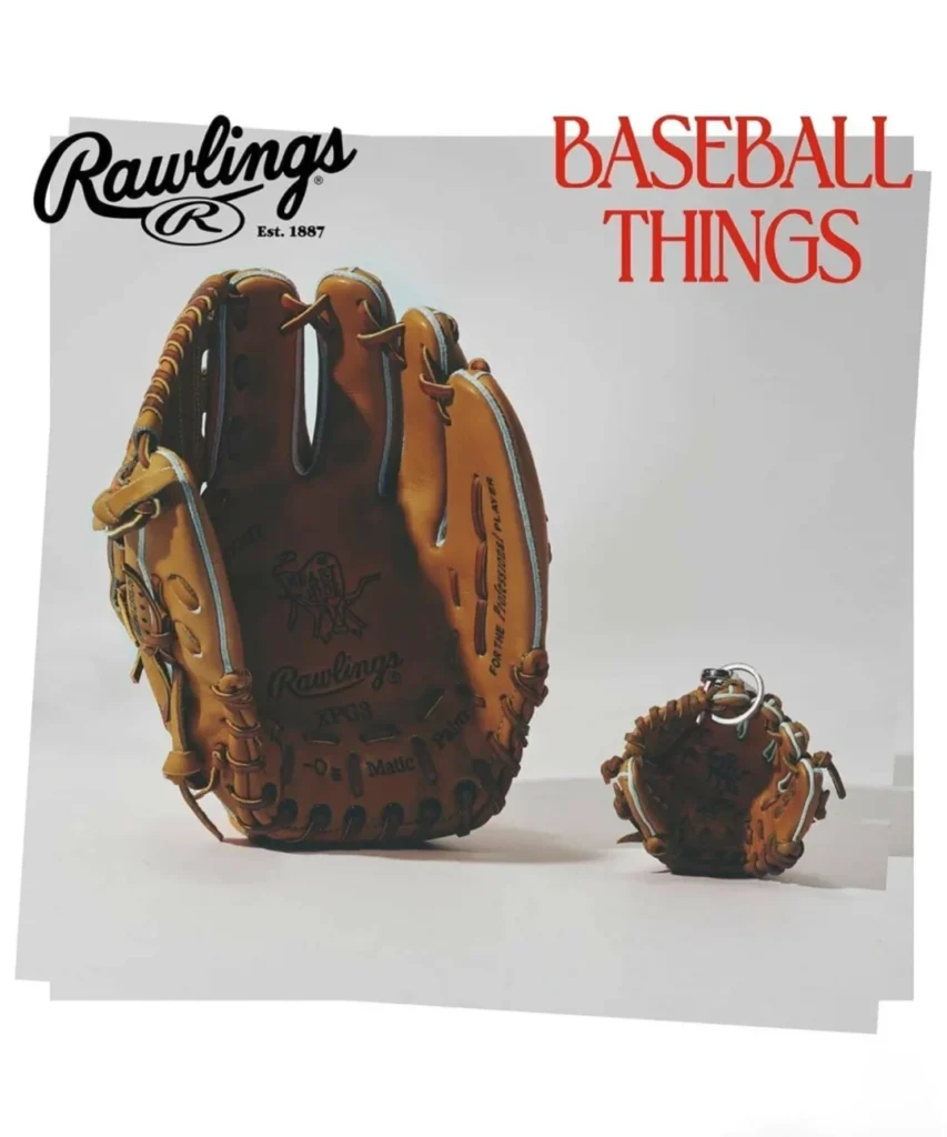Editorial campaign image for Rawlings “Baseball Things” showcasing a classic tan leather baseball glove alongside a miniature glove keychain version, emphasizing hand-laced craftsmanship, heritage player detailing, and nostalgic sports culture styling against a minimalist studio setting