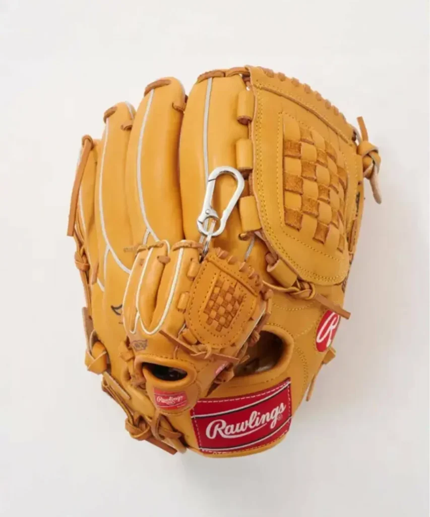 Studio product image of a classic tan Rawlings baseball glove paired with a matching miniature glove keychain accessory, featuring woven leather webbing, contrast piping, silver clasp hardware, and signature red heritage branding against a clean white background