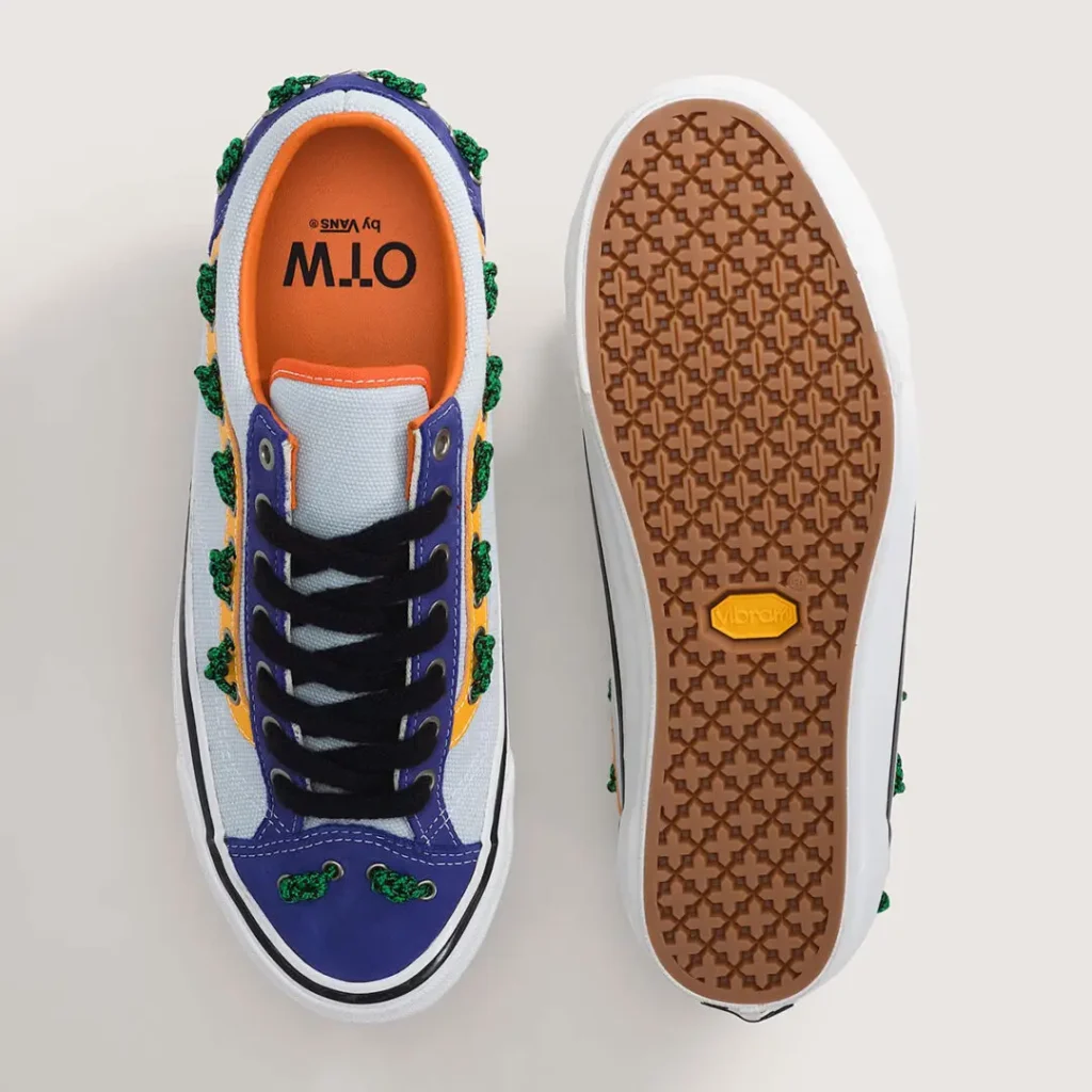 Top and bottom view of the OTW by Vans Old Skool 36 “Knot” in the Royal Cobalt / Multi Blue colorway. The upper combines light blue heavyweight canvas, cobalt suede panels, black fuzzy laces, and nautical green rope knot detailing threaded through the signature side stripe and toe. The reverse reveals a gum-colored Vibram outsole with a geometric traction pattern and yellow logo insert, emphasizing the model’s premium performance upgrade