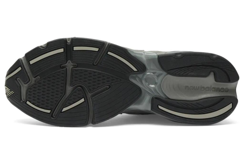 The outsole of the New Balance U2010 3EJ “Harbor Grey” reveals the shoe performance-rooted foundation through a segmented traction layout finished in black and muted grey rubber. Curved flex grooves and sculpted pod sections mirror the fluid geometry of the ABZORB midsole above, while exposed structural detailing through the midfoot emphasizes the silhouette’s Y2K-inspired running DNA. The tread pattern balances durability, flexibility, and everyday grip, reinforcing the shoe’s identity as a comfort-focused lifestyle runner engineered for extended daily wear