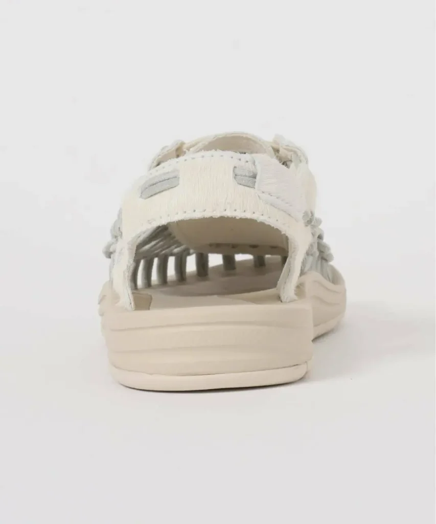 Back view of the cream KEEN sandal displaying the open heel design, textured heel strap with tonal accents, and chunky sculpted sole construction
