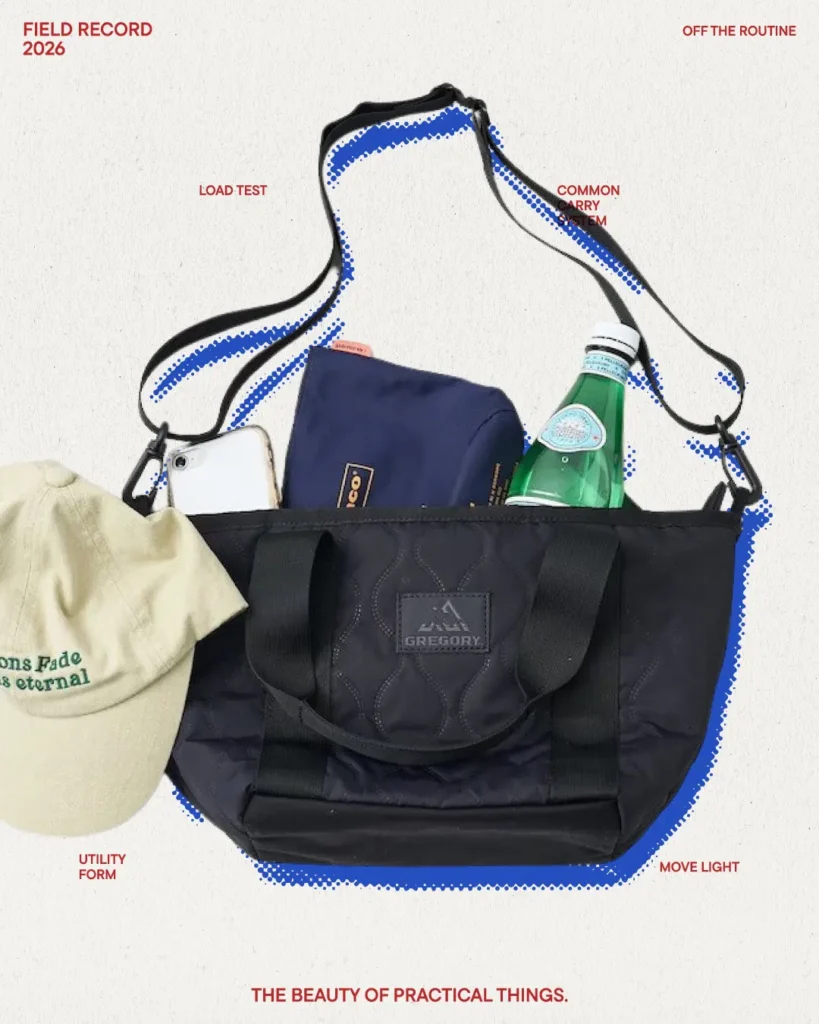 GREGORY black utility tote bag with dual carry handles and shoulder strap shown carrying daily essentials in lifestyle campaign imagery