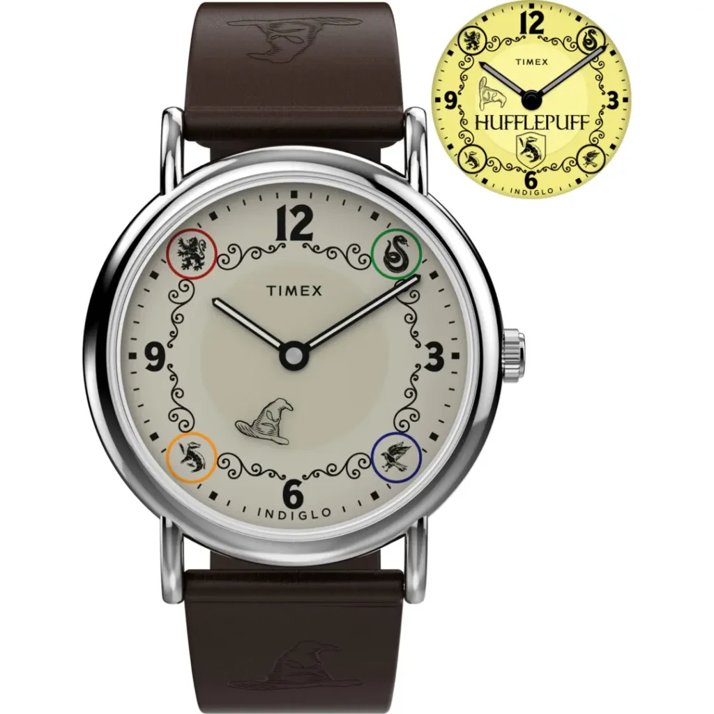 Studio product image of the Timex x Harry Potter and the Philosopher's Stone Hufflepuff Weekender watch featuring a cream dial with Hogwarts house emblems, Sorting Hat illustration at 6 o’clock, polished silver-tone case, brown leather strap embossed with Sorting Hat graphics, and a yellow INDIGLO® backlight preview displaying Hufflepuff branding
