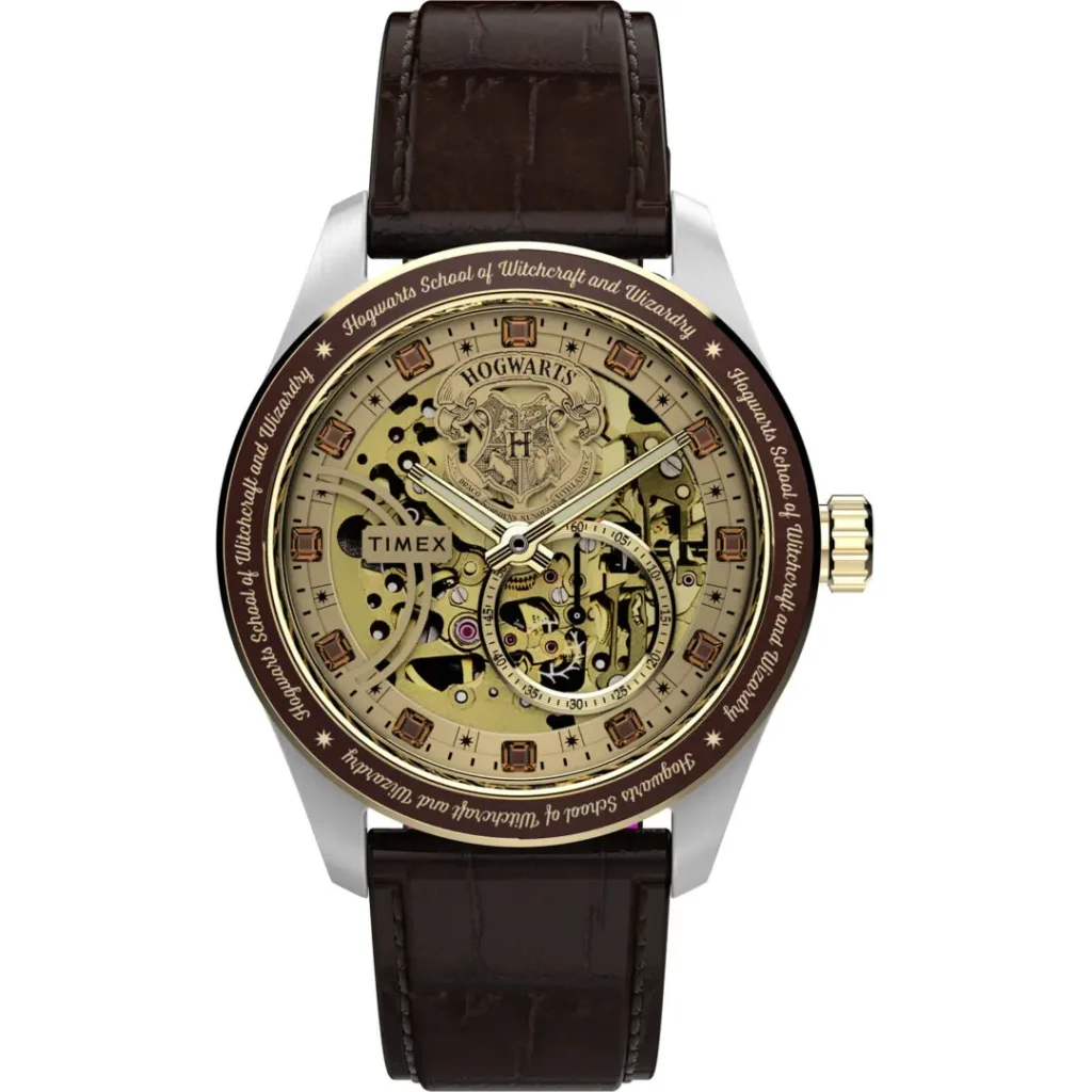 Studio product image of the Timex x Harry Potter and the Philosopher's Stone Waterbury Skeleton Automatic featuring a gold-toned exposed dial, Hogwarts crest centerpiece, brown engraved bezel, faceted crystal hour markers, polished stainless steel case, and dark brown crocodile-grain leather strap against a clean gray background