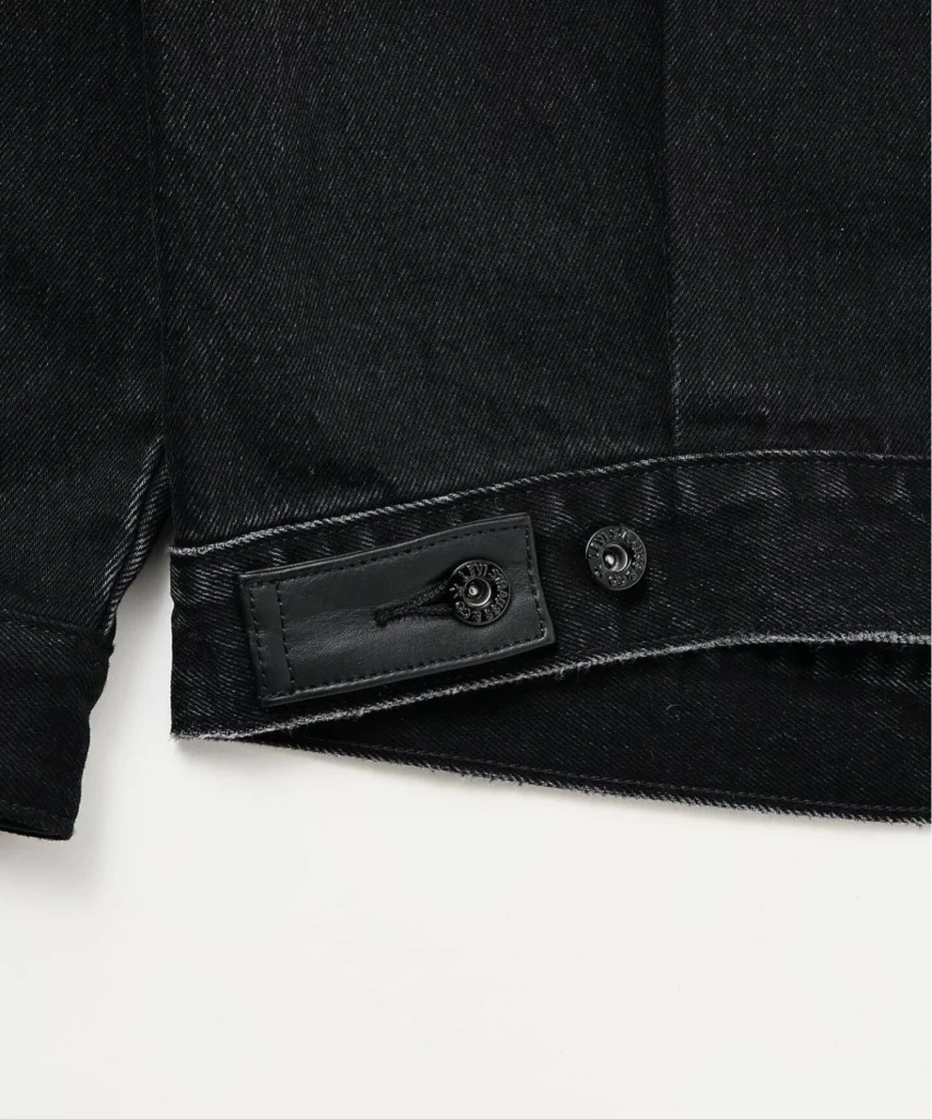 Adjustable waist tab detail with tonal hardware and leather reinforcement, highlighting the craftsmanship of the ÉDIFICE x Levi’s collide