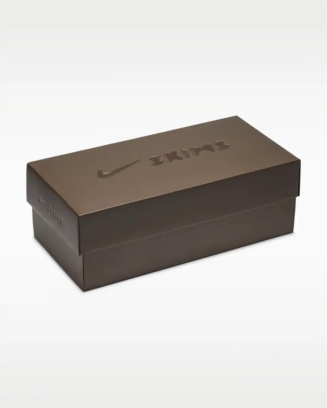 The shoebox continues the collaboration’s muted, elevated aesthetic with a monochromatic brown finish and glossy embossed Nike and SKIMS branding across the lid. Clean, minimal, and intentionally understated, the packaging feels more aligned with luxury ready-to-wear presentation than traditional athletic footwear retail