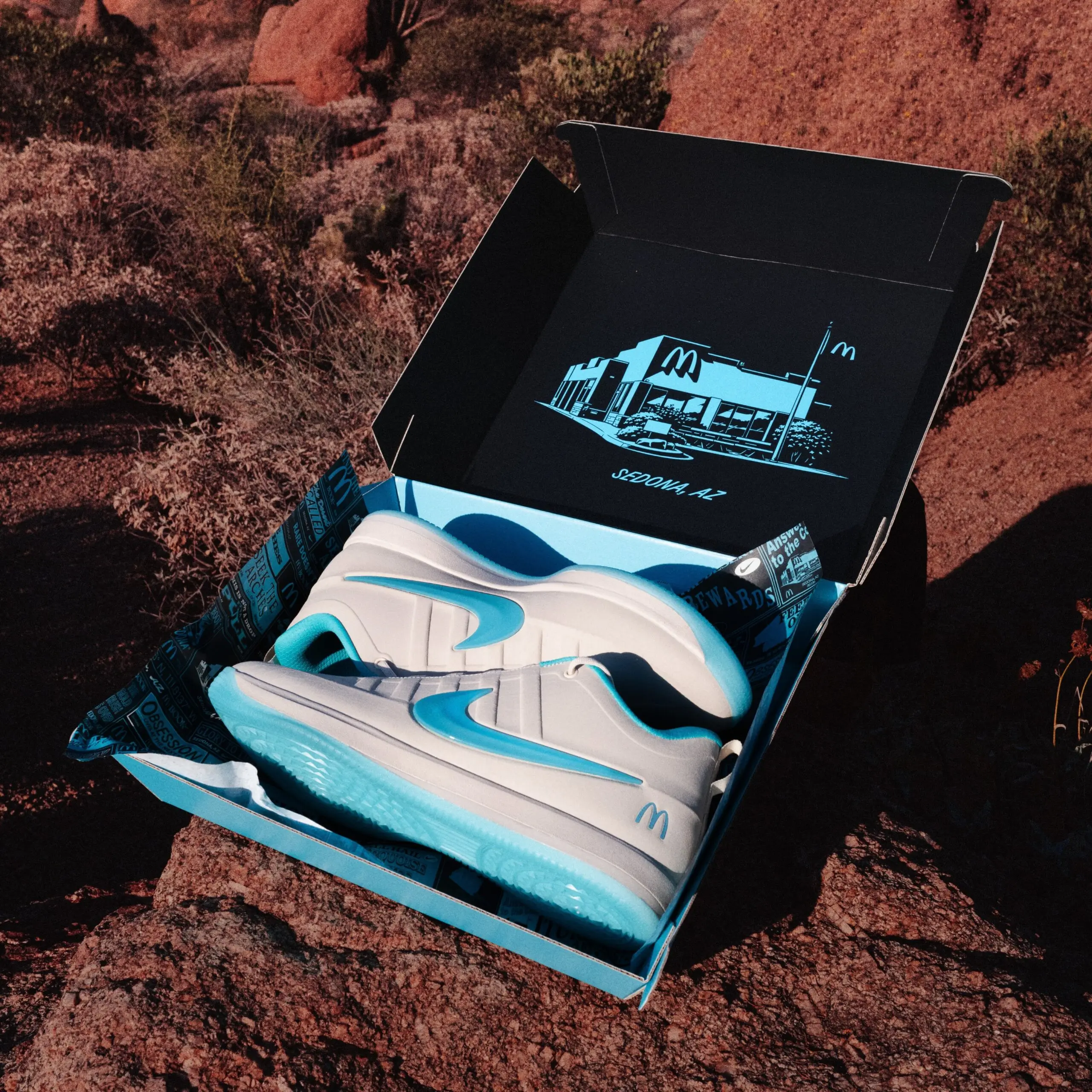 McDonald’s x Nike Book 2 “Sedona” sneakers presented inside a special edition shoebox with custom Sedona, Arizona artwork and desert-inspired turquoise packaging detail