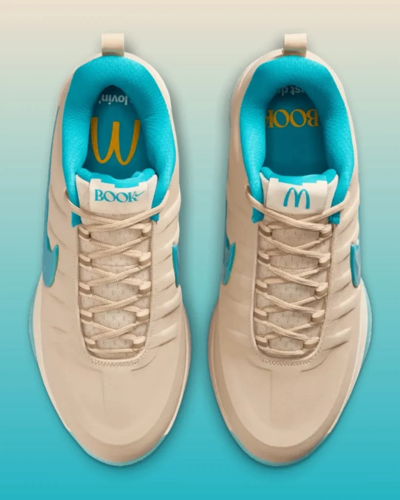 Top-down view of the McDonald’s x Nike Book 2 “Sedona” showcasing turquoise sockliners, co-branded tongue labels, and signature Arizona-inspired color blocking