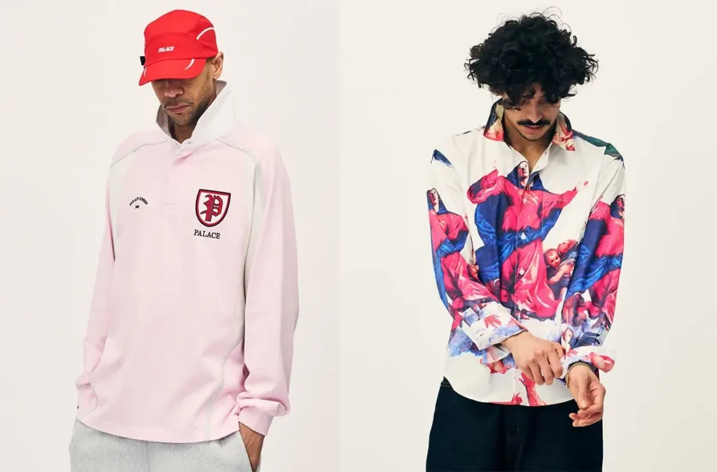 Editorial lookbook image from Palace Summer 2026 showing two styled outfits against a neutral studio backdrop: on the left, a model wears a pale pink rugby-style pullover with Palace crest branding, grey sweatpants, and a bright red technical cap; on the right, another model sports the vivid Renaissance-inspired “Titian Boojie” shirt covered in dramatic classical artwork, paired with dark relaxed-fit trousers and tousled curly hair style
