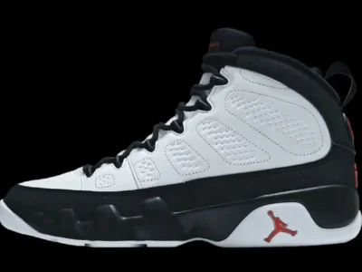Side-profile product image of the Air Jordan 9 'Space Jam' featuring a clean white leather upper with black mudguard overlays, black laces, and signature True Red Jumpman branding near the midsole and heel. The high-top silhouette showcases the Air Jordan 9’s distinctive sculpted midsole design, perforated side panel detailing, and classic 90s basketball aesthetic against a solid black background