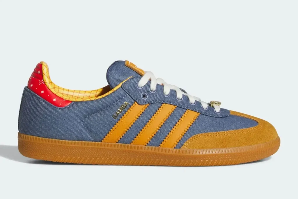 The Woody-inspired adidas Samba translates Toy Story iconography into a surprisingly wearable terrace sneaker. Denim-blue uppers reference Woody’s classic outfit, while caramel suede overlays, gum tooling, and yellow plaid lining reinforce the western aesthetic. Red bandana detailing around the heel adds another direct nod to the character, giving the shoe a playful narrative layer without overpowering the Samba’s timeless silhouette