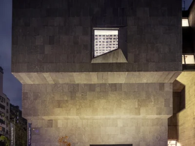 The iconic Marcel Breuer Building on Madison Avenue at dusk, showcasing its cantilevered granite façade and signature trapezoidal window as Sotheby’s global headquarters