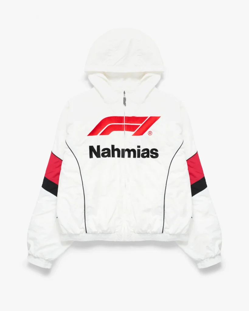 White hooded zip-up jacket with a lightweight, slightly crinkled finish and a relaxed, cropped silhouette. The front features a bold red Formula 1 logo layered above black “Nahmias” lettering, creating a sharp, high-contrast focal point. The sleeves are accented with red and black color-block panels, while curved seam lines trace the body for an aerodynamic, race-inspired look. An adjustable hood, elasticated cuffs, and hem complete the design, blending motorsport functionality with a clean, elevated streetwear edge