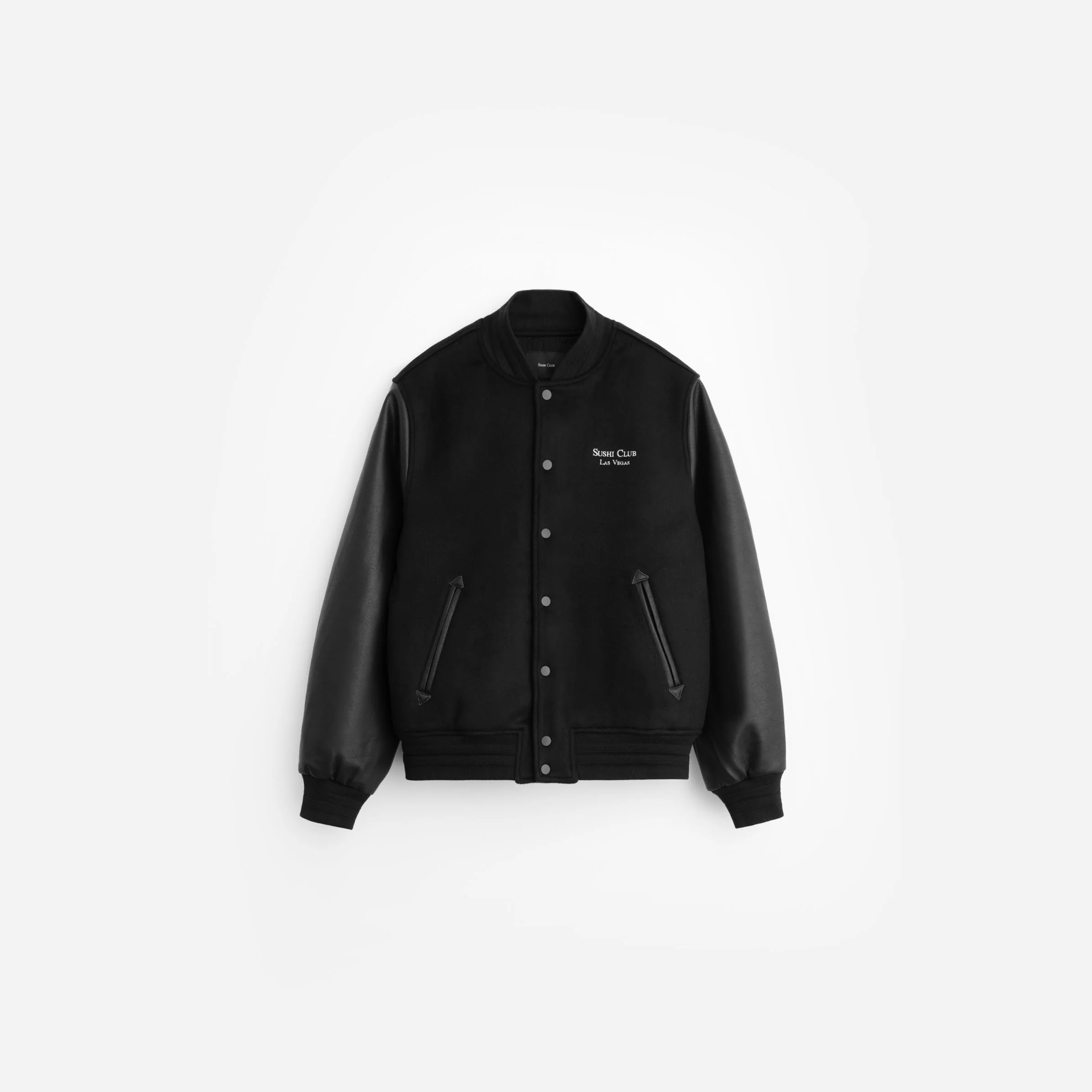 Minimal black varsity jacket with tonal leather-look sleeves, snap-button front closure, and subtle “Sushi Club Las Vegas” embroidery on the chest. The piece features a clean monochromatic design, ribbed trims, and understated streetwear tailoring inspired by classic athletic outerwear and nightlife uniform aesthetics