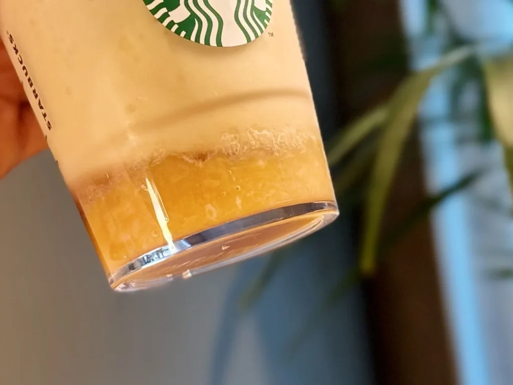 Completed Banana Affogato Frappuccino presented in a Starbucks cup with view banana fruit base and smooth blended texture