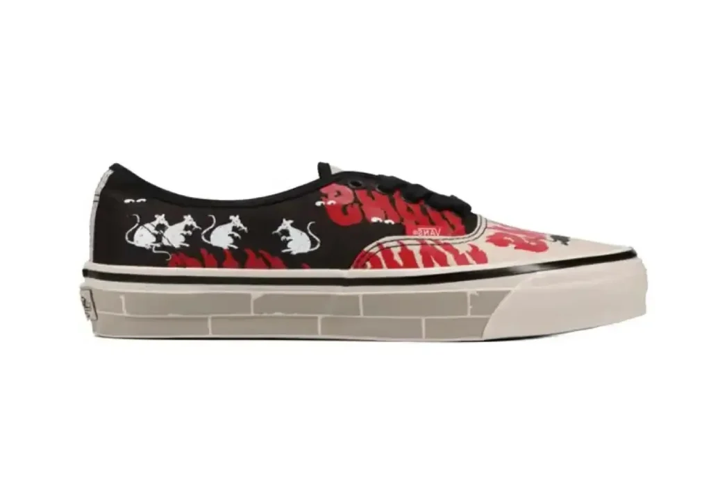 Side-profile product image of the Vans x SOON.EASY Premium LX Authentic 44 shoe in a black, off-white, and red palette. The canvas upper features oversized hand-drawn typography, playful cartoon-style character illustrations marching across the side panel, and expressive graphic overlays. Black laces and a lightly distressed off-white vulcanized sole complete the artistic, socially charged reinterpretation of Vans’ classic silhouette