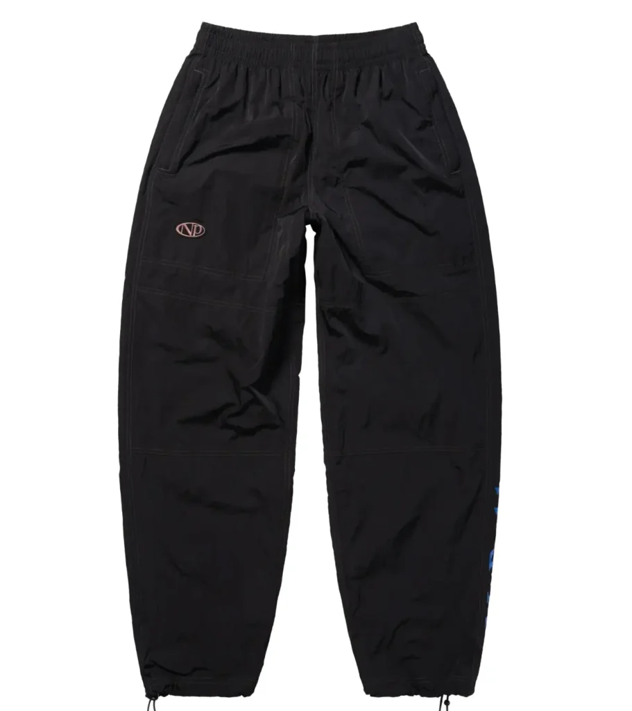Black technical track pants with a relaxed tapered silhouette, featuring subtle logo detailing, utility-style seam construction, and adjustable drawcord hems in a clean studio product presentation against a light-gray background