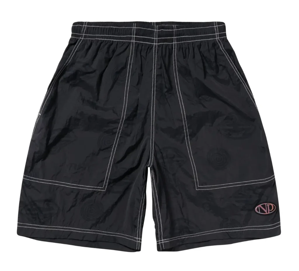 Black nylon shorts with contrast white stitching, featuring subtle tonal graphic patterns throughout and a small oval logo detail near the hem, styled in a clean studio product shot against a light-gray background